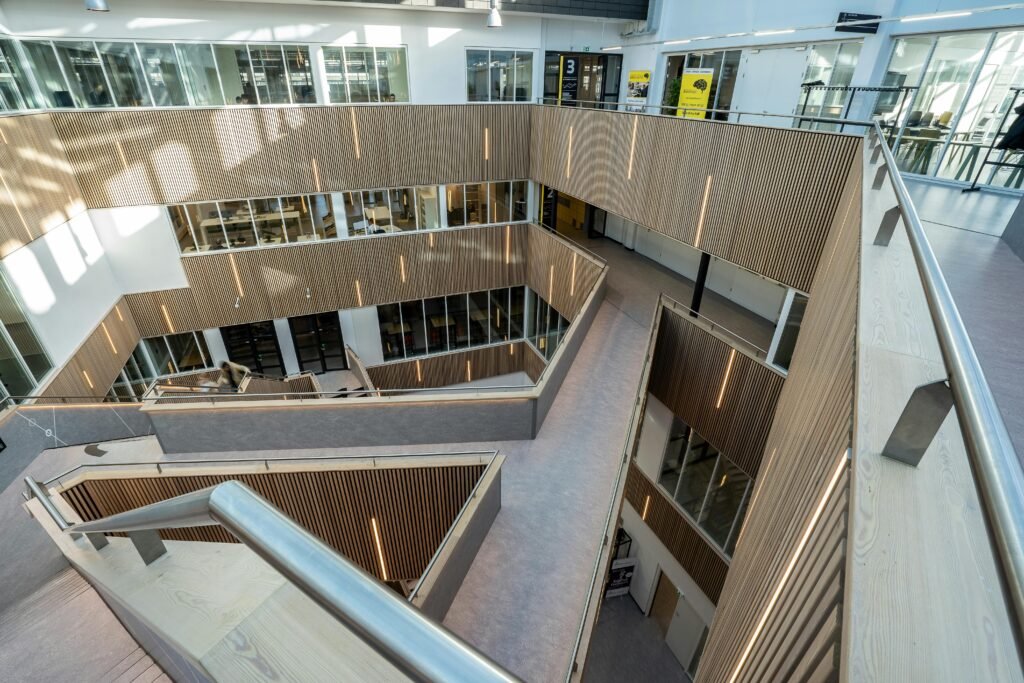 Spacious modern office building interior featuring sleek railings and open design.